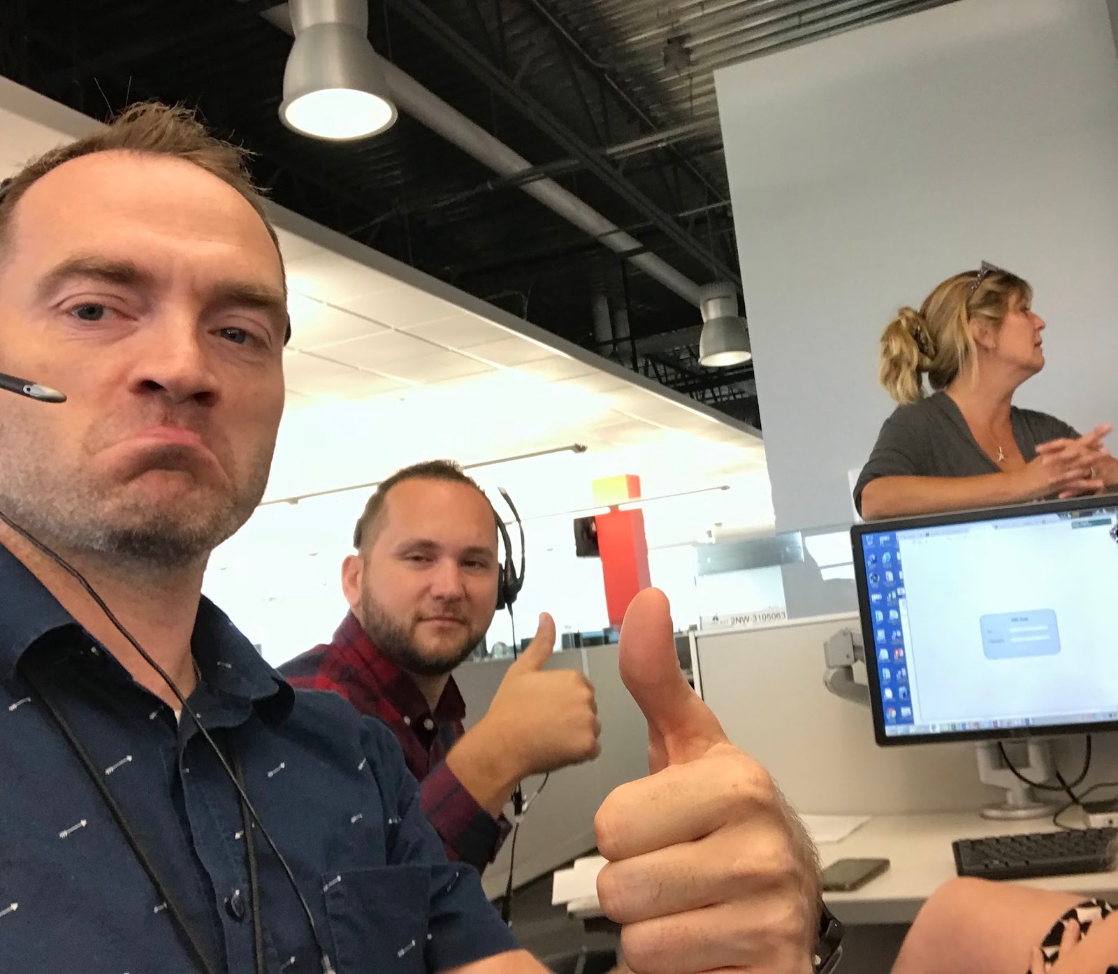 Ash with team members at a call center